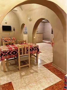 a room with a table and chairs and a television at Kareem Hotel Luxor in Luxor +106 photos
