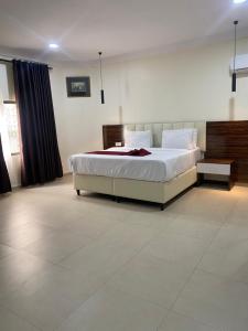 a bedroom with a large bed in a room at Chateux de atlantique Hotel in Lagos