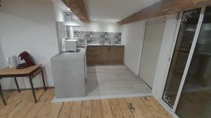 a kitchen with a counter and a table in a room at La commanderie in Homps