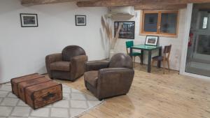 a living room with two chairs and a table at La commanderie in Homps