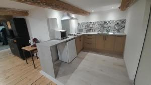a kitchen with a sink and a stove top oven at La commanderie in Homps