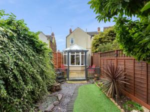 a house with a gazebo in a yard at 7 Guests - 6 Bedroom - Free Wi-Fi - NN15 in Burton Latimer