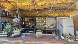 a kitchen with a table and a refrigerator at Kosmik House in Punta Del Diablo +19 photos