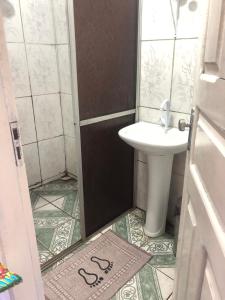 a small bathroom with a sink and a toilet at Hospedagem Familia Lima in Belém