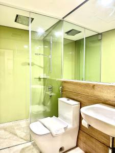 a bathroom with a toilet and a sink and a shower at Sky Suites KLCC Glorious in Kuala Lumpur +12 photos