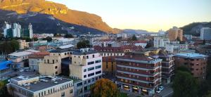 a city with buildings and a mountain in the background at Bovara 49 in Lecco