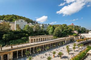 a view of a train station in a city at Hotel Ontario in Karlovy Vary
