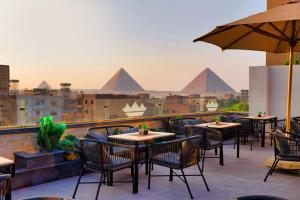 a restaurant with a view of the pyramids at Taj Pyramids View Hotel & Suites in Cairo