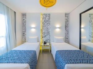 Ένα ή περισσότερα κρεβάτια σε δωμάτιο στο Golden Tower Maracanaú by Fênix Hotéis