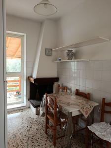 a kitchen with a table and chairs and a fireplace at La Villetta in Vittorito