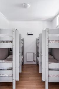 a room with four white bunk beds in it at Large apartment in ski resort Kungsberget in Järbo