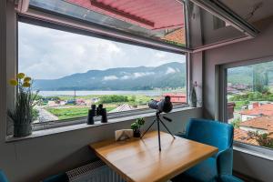 a window in a room with a wooden table and blue chairs at Ardo Spa Hotel and Restaurant in Sarnitsa