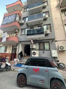 a small car parked in front of a building at NR1 Pansiyon in Canakkale