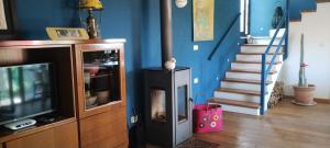a living room with a tv and a staircase at Casa Rosa Istria in Kućibreg
