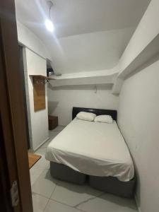 a bedroom with a bed in a white room at NR1 Pansiyon in Canakkale +26 photos