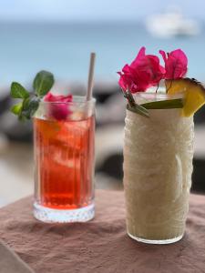 two cocktails on a table with a flower on top at Ti Valy in Saint-François +31 photos