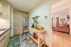 a kitchen and living room with a table in a room at Iconic Center in Seville