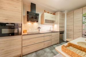 a kitchen with wooden cabinets and a counter top at Iconic Center in Seville +7 photos