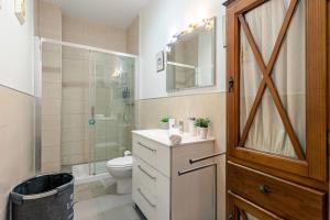 a bathroom with a toilet and a shower and a sink at Iconic Center in Seville