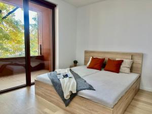 a bedroom with a large bed with red pillows at Bratislava in Nivy