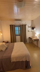 a bedroom with a large bed and a window at Casa en el Quebrachito in Formosa +53 photos