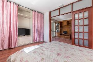 a bedroom with a large bed and a television at La Villa Alba by BarbarHouse in Leporano Marina