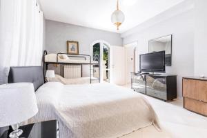 a bedroom with two bunk beds and a flat screen tv at La Villa Alba by BarbarHouse in Leporano Marina +41 photos