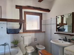 a bathroom with a sink and a toilet and a window at AL30 Studios in Viverone +37 photos