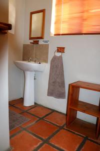 a bathroom with a sink and a mirror at Asher Riverside Cottages in Bonnievale +20 photos