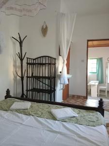 a bedroom with a bed and a mirror at Tango house in Ukunda