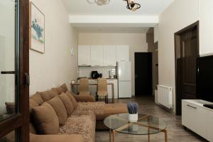 a living room with a couch and a table at HD Didveli Apartment in Bakuriani