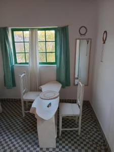 a room with two chairs and a table and a window at Tango house in Ukunda