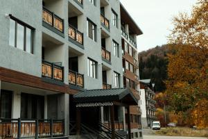 an apartment building with an awning in front of it at HD Didveli Apartment in Bakuriani