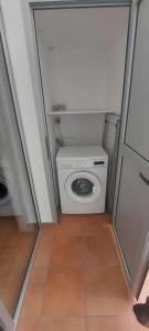 a small bathroom with a washing machine in a room at Vv Faro in Puerto de Mogán +6 photos