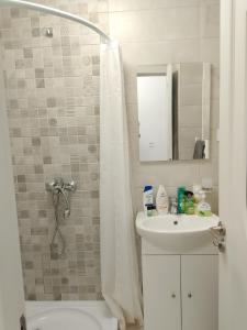 a bathroom with a toilet and a sink and a shower at Apartament Milcov in Galaţi