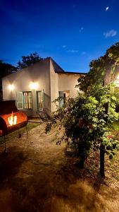 a house with a fire in front of it at Casa en el Quebrachito in Formosa