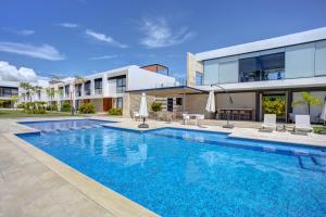 a swimming pool in front of a house at Vista Natura, Luxury Home Near the Beach in Nuevo Vallarta 