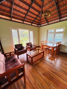 a living room with wooden furniture and a table at Estate stay near Dubare elephant camp, friendly for remote workers in Siddapur