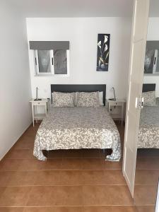 a bedroom with a bed and two tables at Vv Velero in Puerto de Mogán