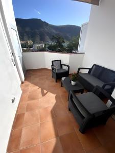a living room with a couch and chairs on a balcony at Vv Velero in Puerto de Mogán