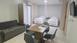 a living room with a couch and a table and chairs at Mendes Residence in Belém