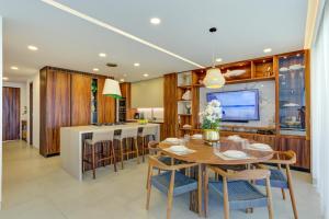 a dining room and kitchen with a table and chairs at Vista Natura, Luxury Home Near the Beach in Nuevo Vallarta 