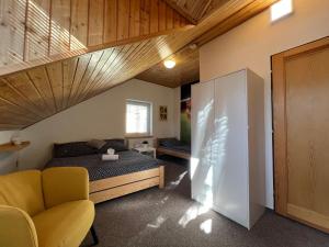 a bedroom with a bed and a staircase in a room at Relax Centrum Gól in Loučná nad Desnou