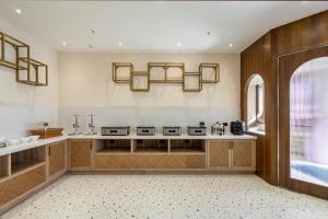 a kitchen with a counter and a sink in a room at Monday Premium Madhapur in Hyderabad
