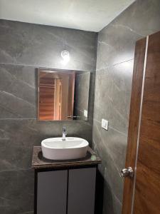 a bathroom with a sink and a mirror at Estate stay near Dubare elephant camp, friendly for remote workers in Siddapur