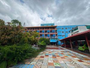 a building with a tile walkway in front of a building at OYO 75596 The Sirisuk House in Ban Nong Nae