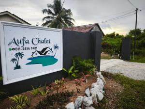 a sign for a resort with a boat on it at OYO 91244 Aufa Chalet in Kuala Terengganu +29 photos