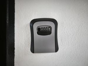 a remote control is attached to a wall at OYO 91244 Aufa Chalet in Kampong Ru Tujoh