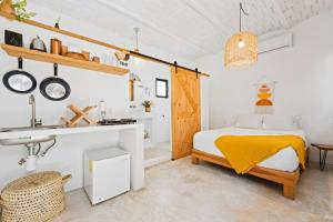 a white bedroom with a bed and a sink at Downtown SURF SHACK- steps from main surf break in Sayulita +18 photos