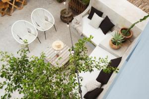 an overhead view of a patio with white furniture and plants at Downtown SURF SHACK- steps from main surf break in Sayulita